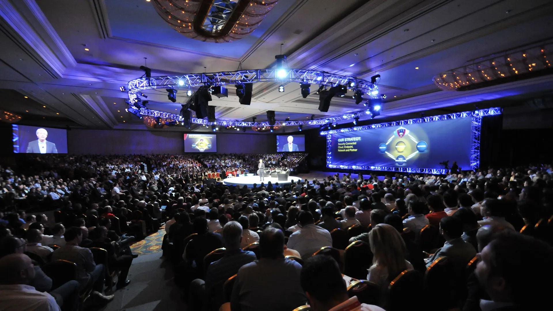 Large-scale corporate conference photography in Arizona with keynote speaker addressing a packed executive audience